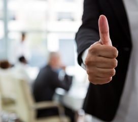 Businesswoman showing thumbs up